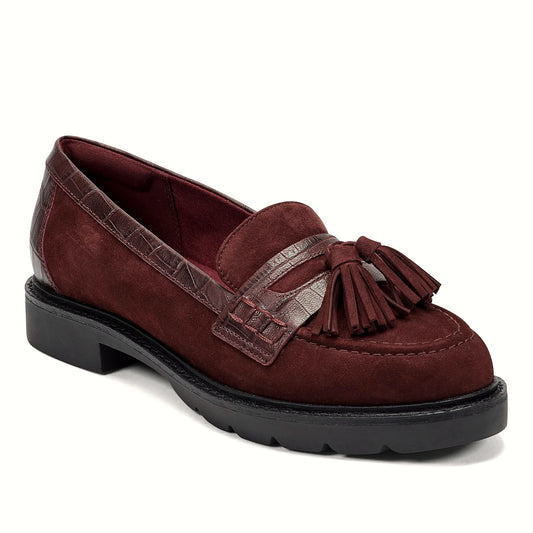 Close view of the polished tassel and woven keeper strap on a loafer