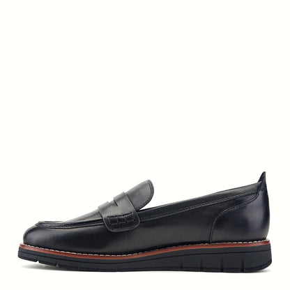 Pair of penny strap loafers photographed from above on a plain background
