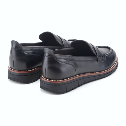 Rear view of a penny loafer showing the subtle wedge profile