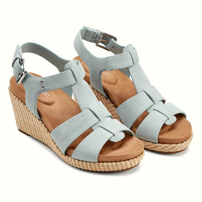 Close view of the metal stud accents and looped bands on a wedge sandal