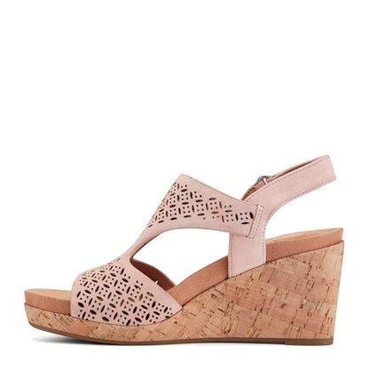 Pair of perforated wedge sandals photographed from above on a plain background