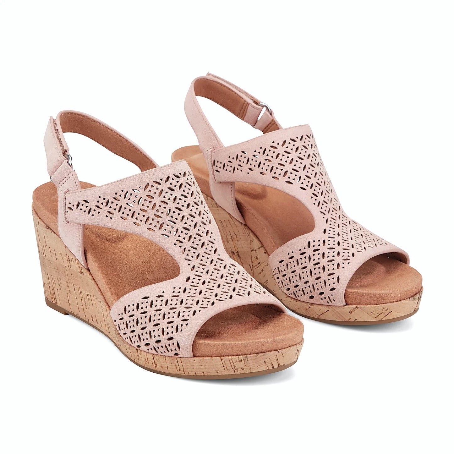 Close view of the geometric floral perforation across a wedge sandal strap