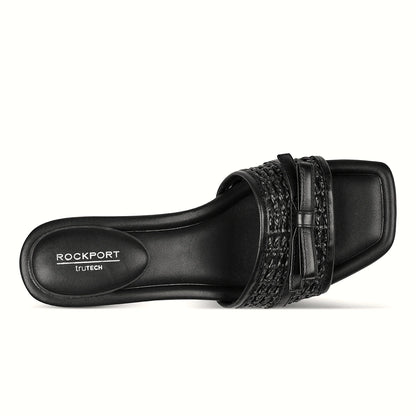 Pair of bow slide sandals photographed from above on a plain background