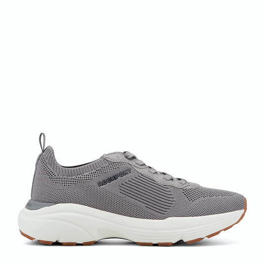 Side view of a medium gray knit sneaker with tonal overlays along the laces