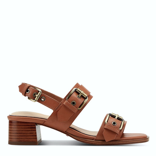 Side view of a light natural leather slingback sandal on a stacked block heel