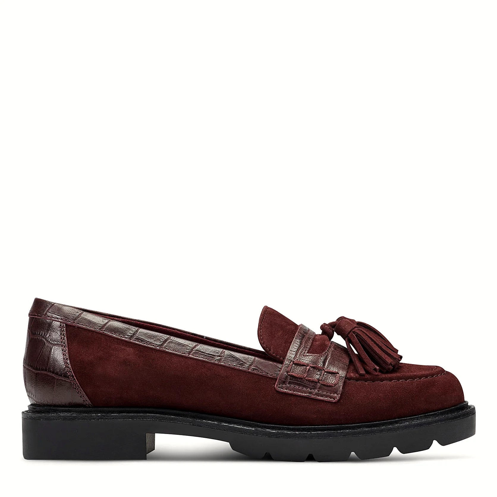 Side view of a dark red suede tassel loafer on a lugged rubber outsole