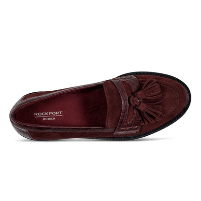 Pair of tassel lug loafers photographed from above on a plain background