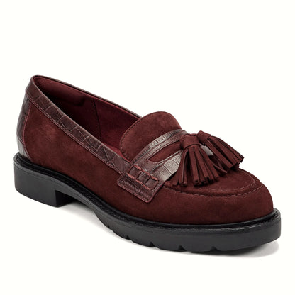 Close view of the polished tassel and woven keeper strap on a loafer