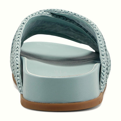 Rear view of a flat slide sandal showing the nubby traction outsole