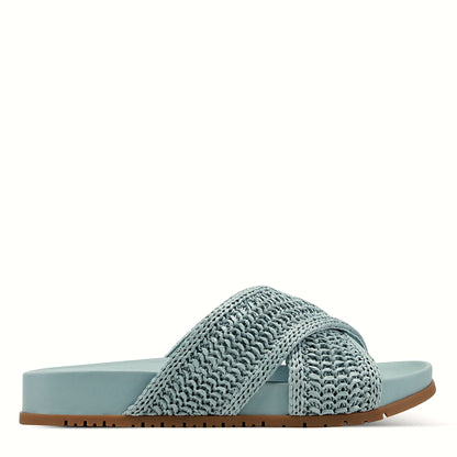Side view of a medium blue slide sandal with crisscross straps