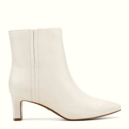 Side view of an ivory calf hair dress bootie at ankle height
