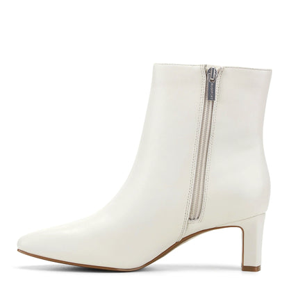 Pair of calf hair dress booties photographed from above on a plain background