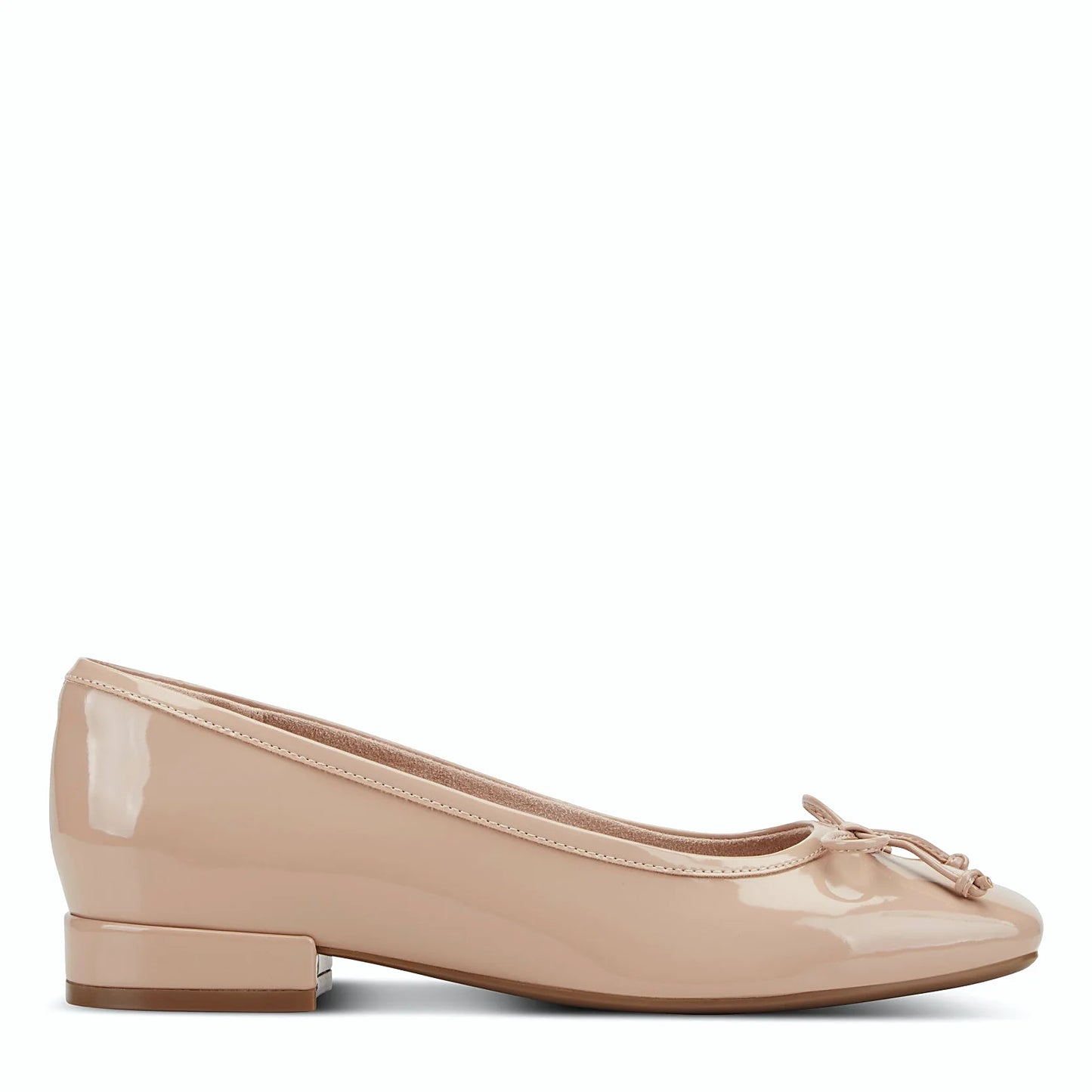 Side view of a light natural patent ballet flat with a low block heel