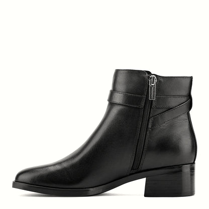 Pair of ankle booties photographed from above on a plain background