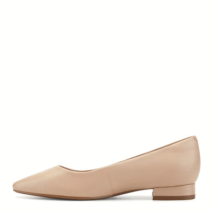 Pair of pointed slip-on flats photographed from above on a plain background
