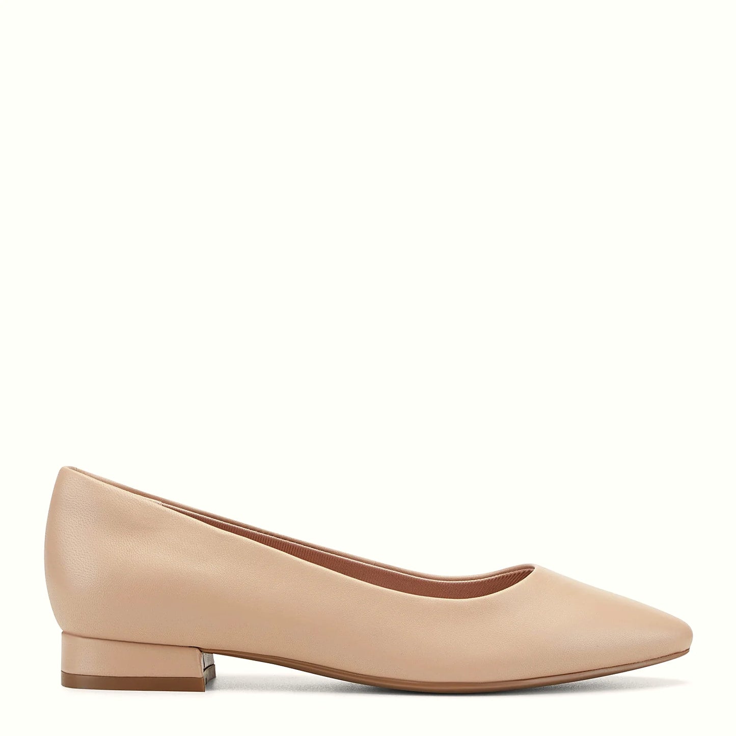 Side view of a light natural leather pointed flat with a slip-on silhouette