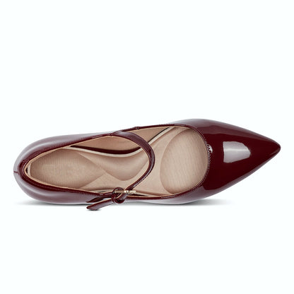 Pair of buckled mary jane pumps photographed from above on a plain background