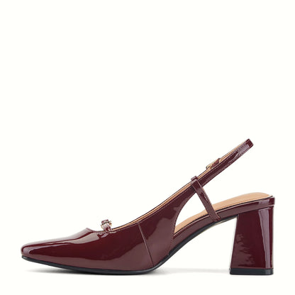 Pair of patent slingback pumps photographed from above on a plain background