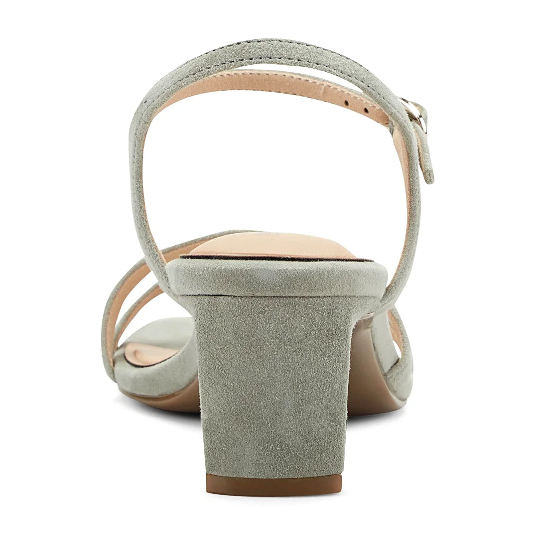 Rear view of a dress sandal showing the block heel and ankle strap
