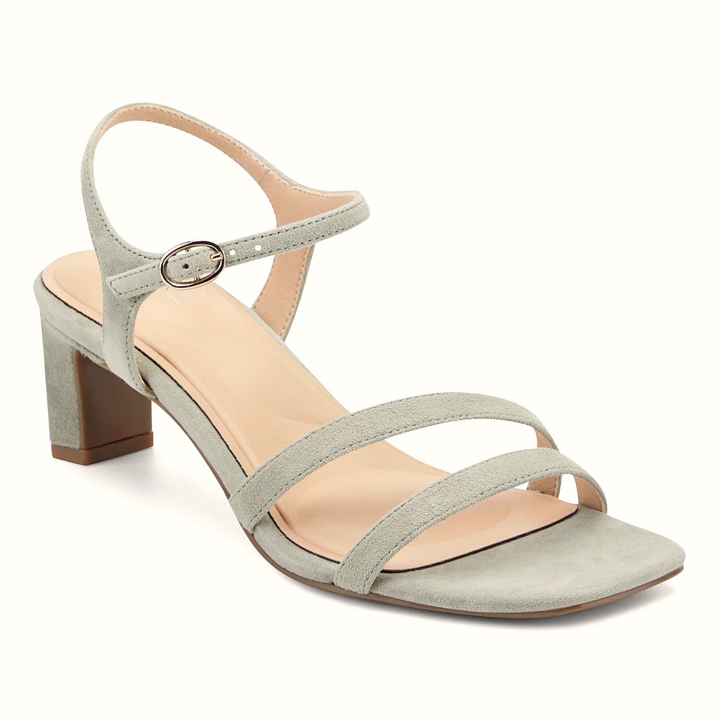 Close view of the polished oval buckle on the ankle strap of a sandal