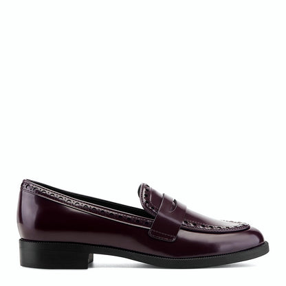Side view of a dark red patent penny loafer with brogue perforations