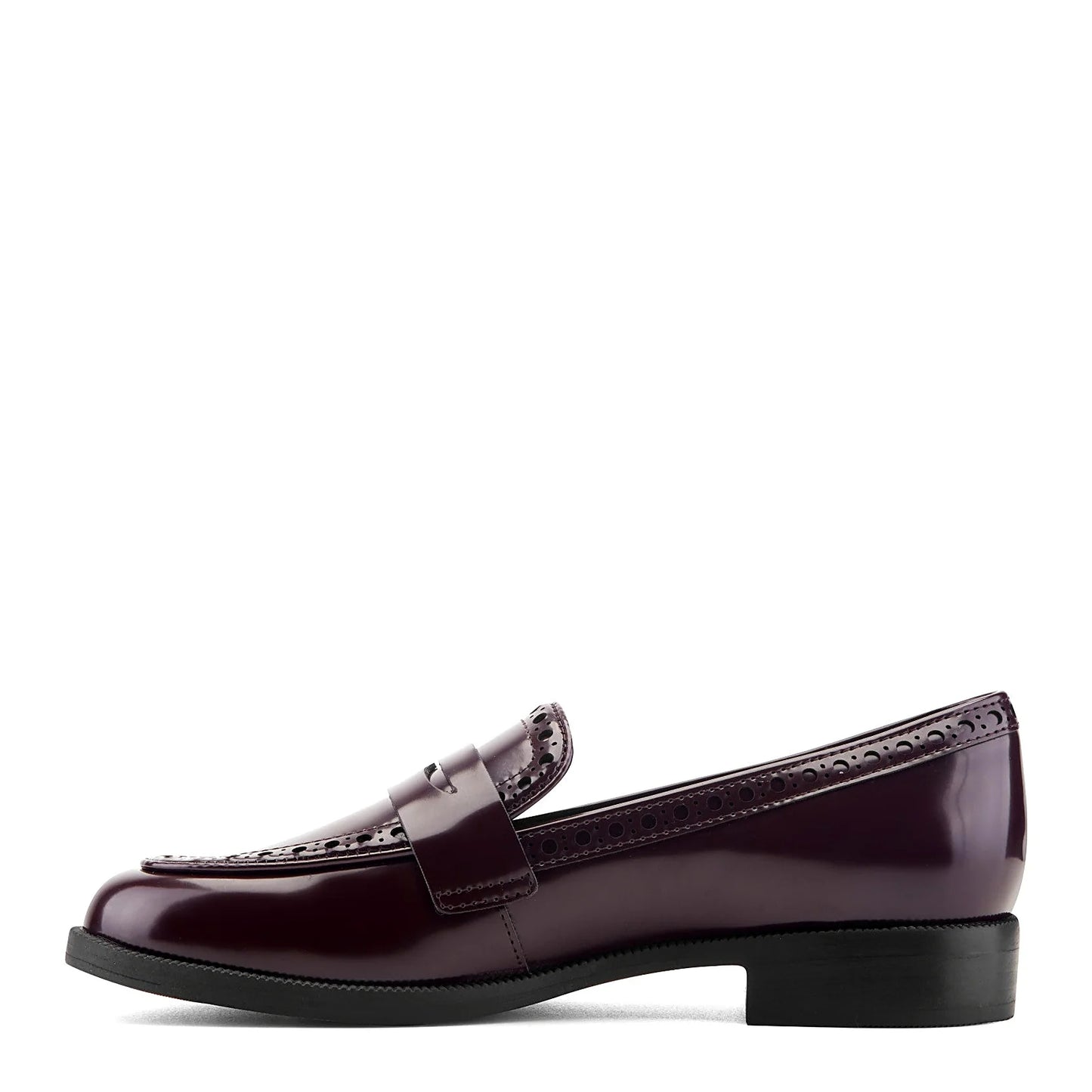 Pair of brogued penny loafers photographed from above on a plain background