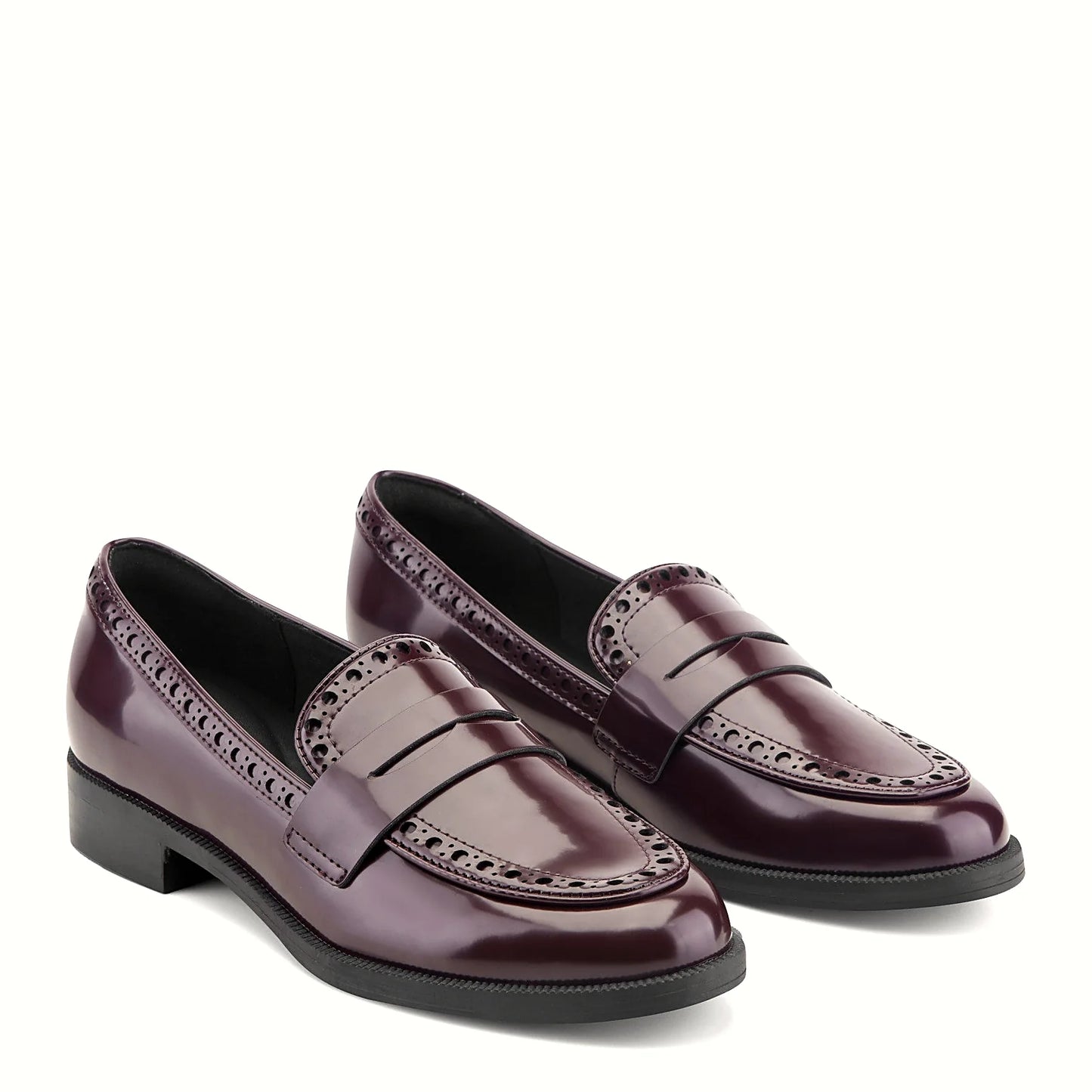 Close view of the perforated vamp and structured penny strap on a loafer