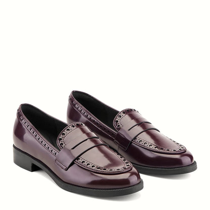 Close view of the perforated vamp and structured penny strap on a loafer