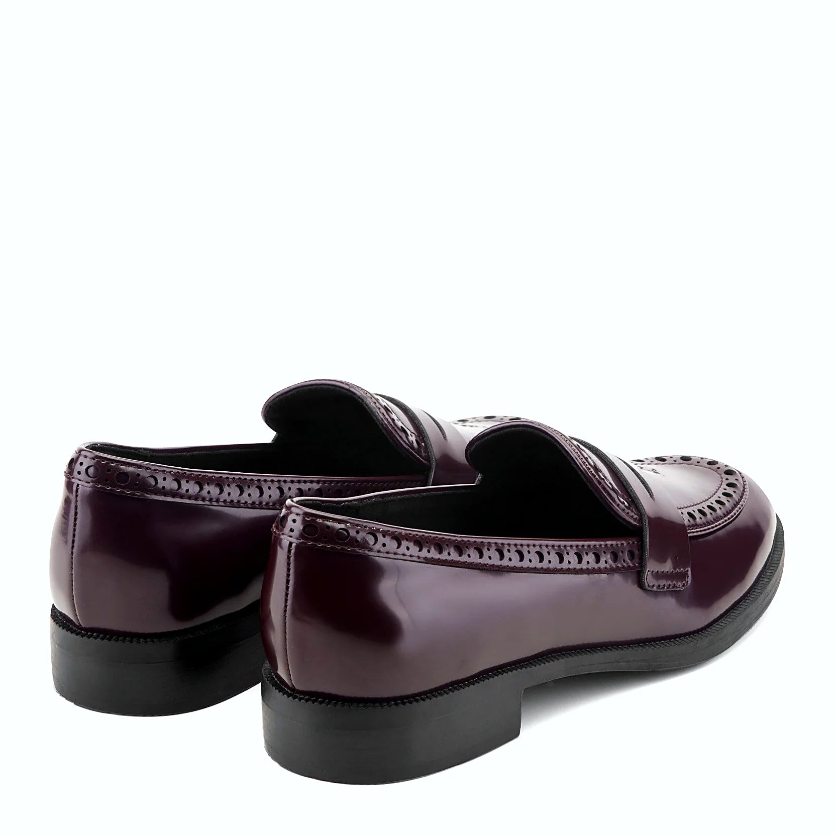 Rear view of a penny loafer showing the low stacked heel and treaded outsole