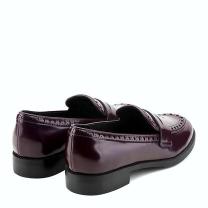 Rear view of a penny loafer showing the low stacked heel and treaded outsole