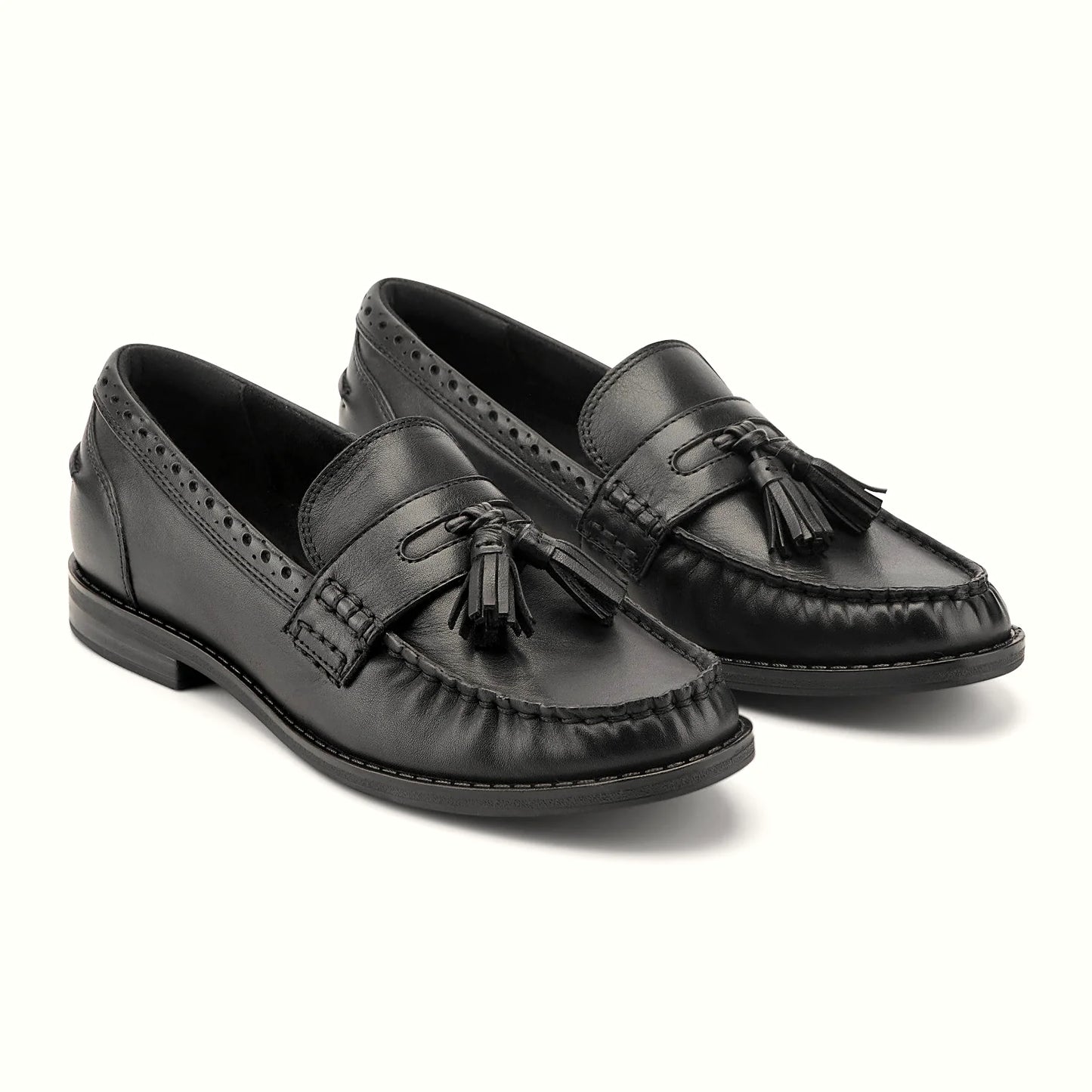 Close view of the brogue-punched collar and tassel detail on a loafer