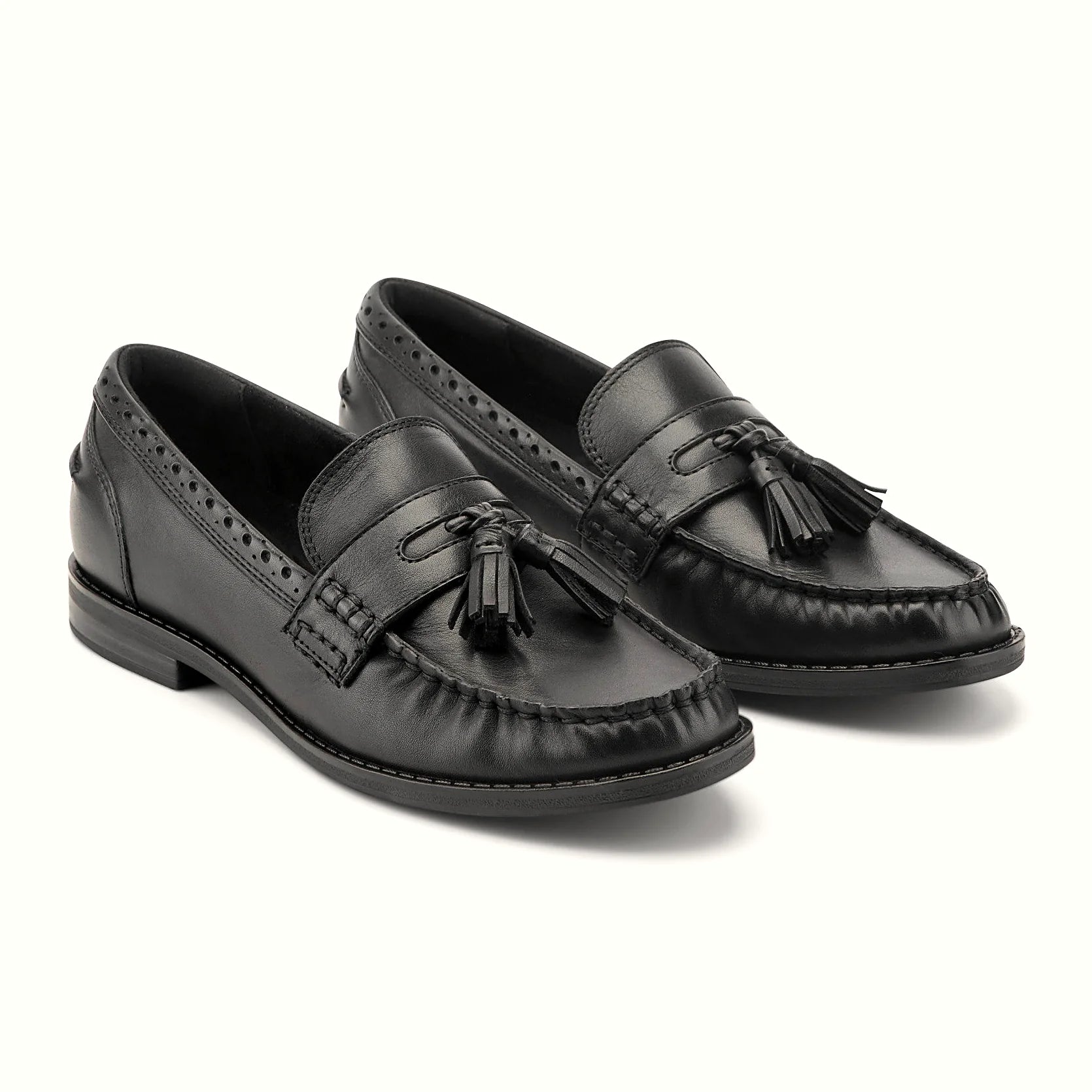 Close view of the brogue-punched collar and tassel detail on a loafer