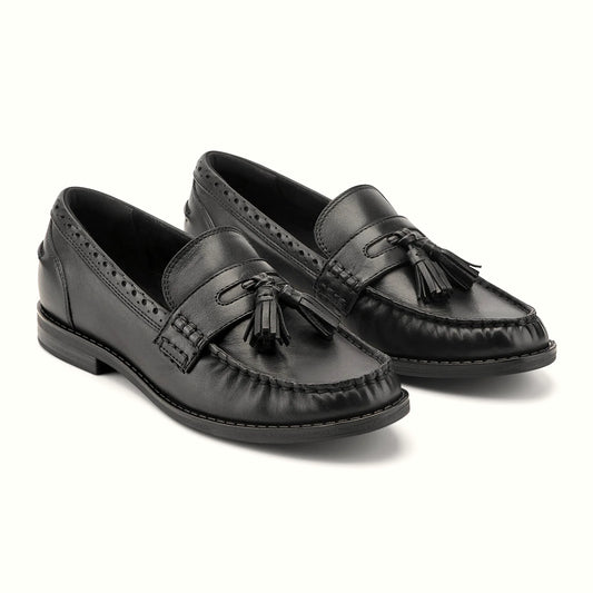 Close view of the brogue-punched collar and tassel detail on a loafer