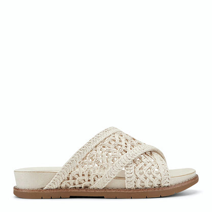 Side view of an ivory slide sandal with an open lattice upper
