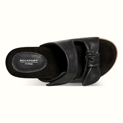 Pair of knotted two-strap sandals photographed from above on a plain background